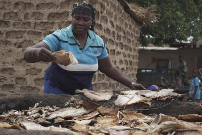 woman preparing smoked fish